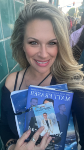 Maile Navarro standing outside The Wiltern holding Matt Fraser’s books and VIP pass while waiting for her scheduled meet and greet.